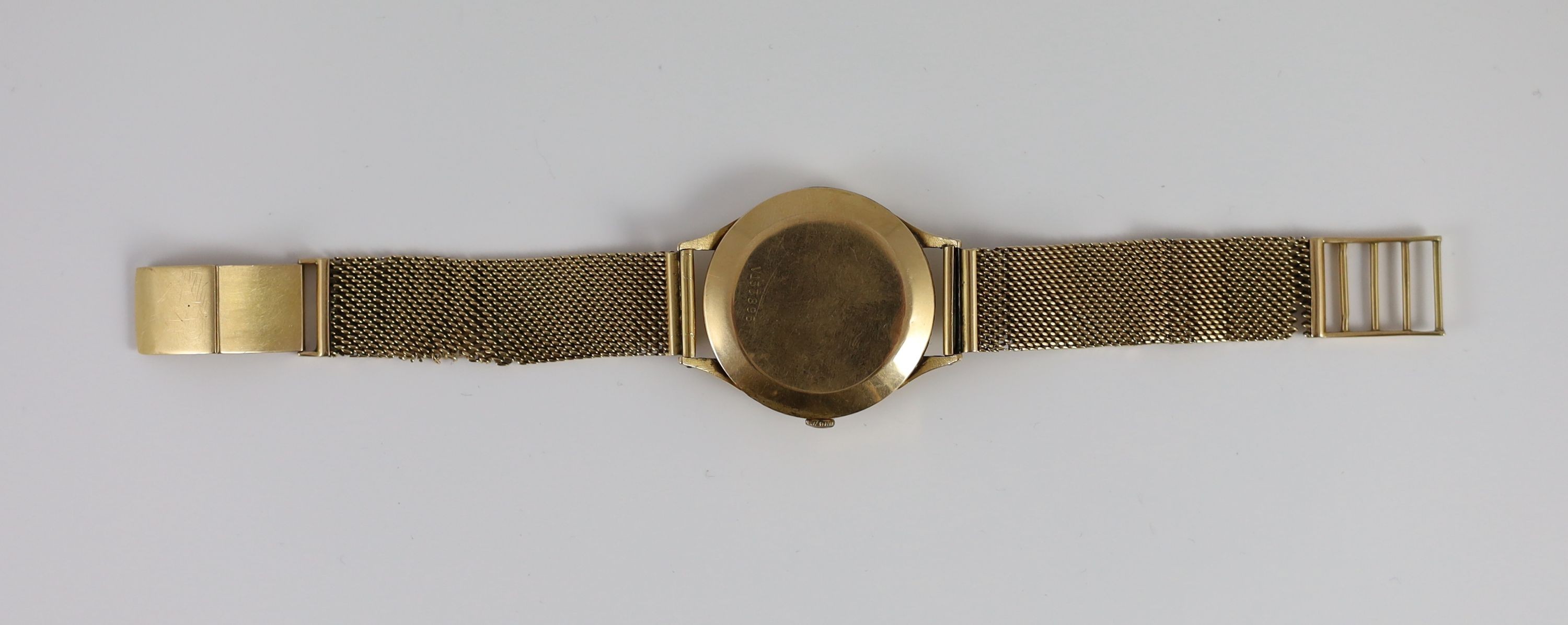 A gentleman's 1950's 18ct gold Omega manual wind wrist watch, on an Italian 750 yellow metal mesh link bracelet